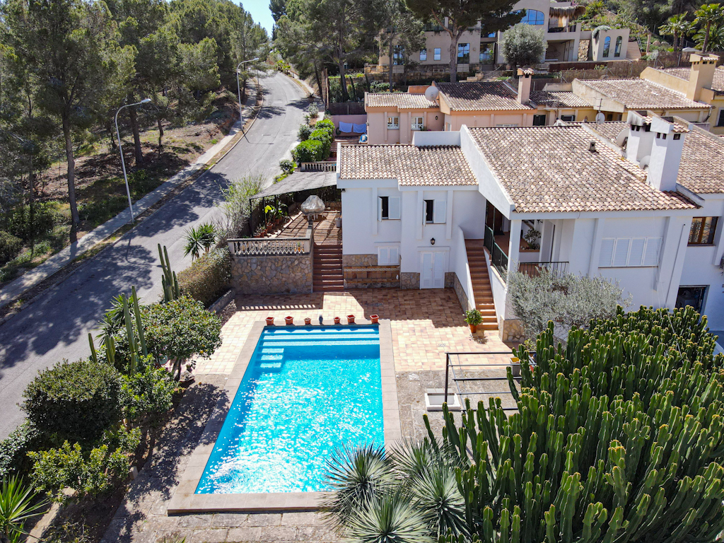 An image of a delightful home at the beach in Santa Ponsa, showcasing a perfect blend of coastal charm and modern design. The house features large windows that open up to stunning beach views, with a spacious terrace or balcony ideal for enjoying the sea breeze. Inside, the open-plan living spaces are light and airy, offering stylish décor and comfortable furnishings. The outdoor area includes a beautiful garden and possibly a private pool, creating a serene and private retreat by the beach.