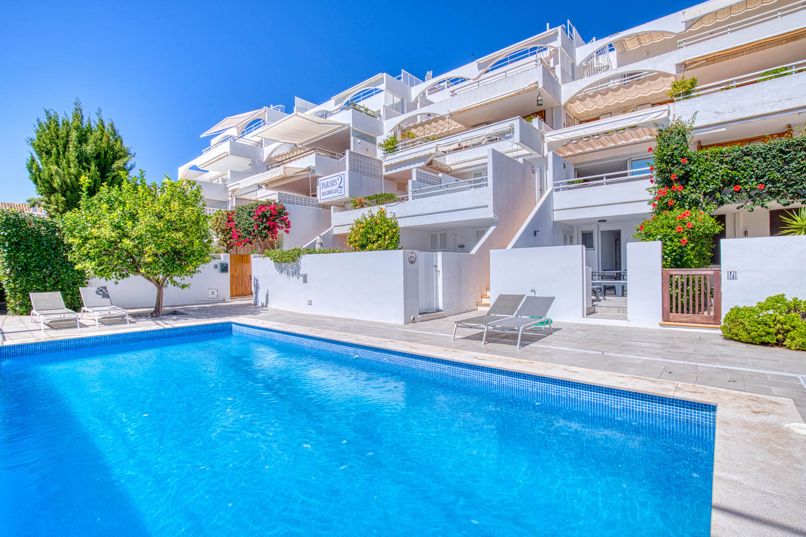 An image of a stunning frontline apartment in Port Andratx, featuring unobstructed views of the sparkling Mediterranean Sea. The apartment boasts a sleek, modern design with large windows that allow natural light to flood the space, creating a bright and airy atmosphere. A spacious terrace or balcony extends from the living area, offering the perfect spot to enjoy the beautiful coastal scenery. The prime location and elegant interior make this apartment an exclusive and desirable retreat by the water.