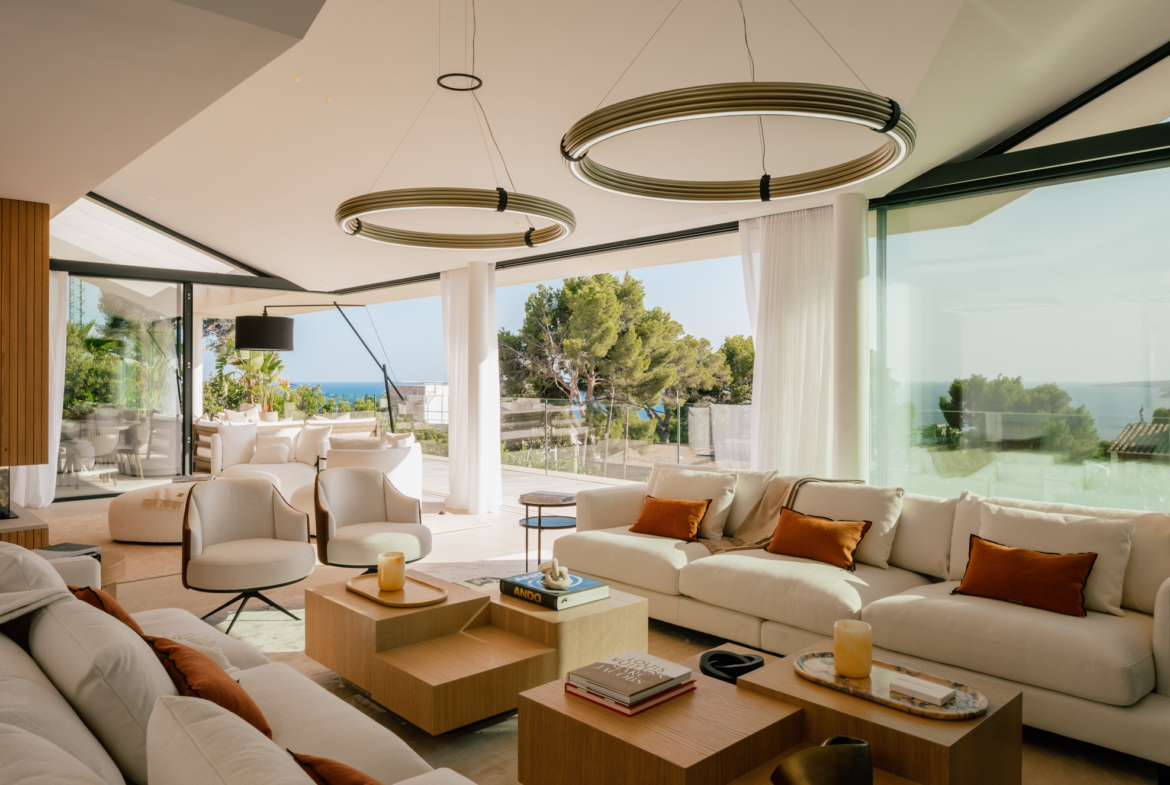 Luxurious living room with sleek decor and large windows overlooking the sea