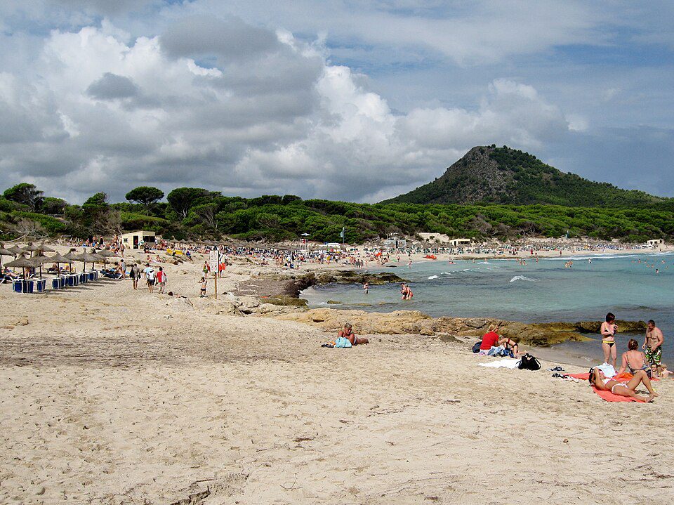 Cala Agulla beach with hills behind