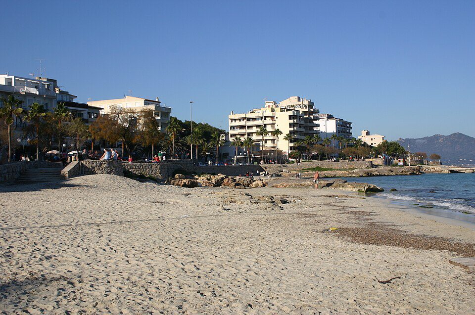 Sandy shore and seafront buildings at Cala Millor