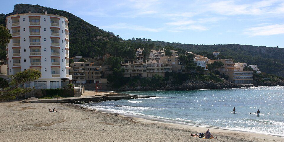 Sandy beach and waterfront buildings at Sant Elm