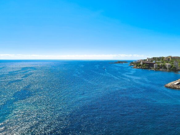 An image of an elegant apartment in a prime location, offering stunning sea views. The apartment features modern architecture with large windows that frame the breathtaking coastal scenery. The open-plan living area is bright and airy, with stylish finishes and a seamless flow to a private balcony or terrace. Perfectly positioned to enjoy the beauty of the ocean, this apartment combines luxury living with an enviable location near the sea.